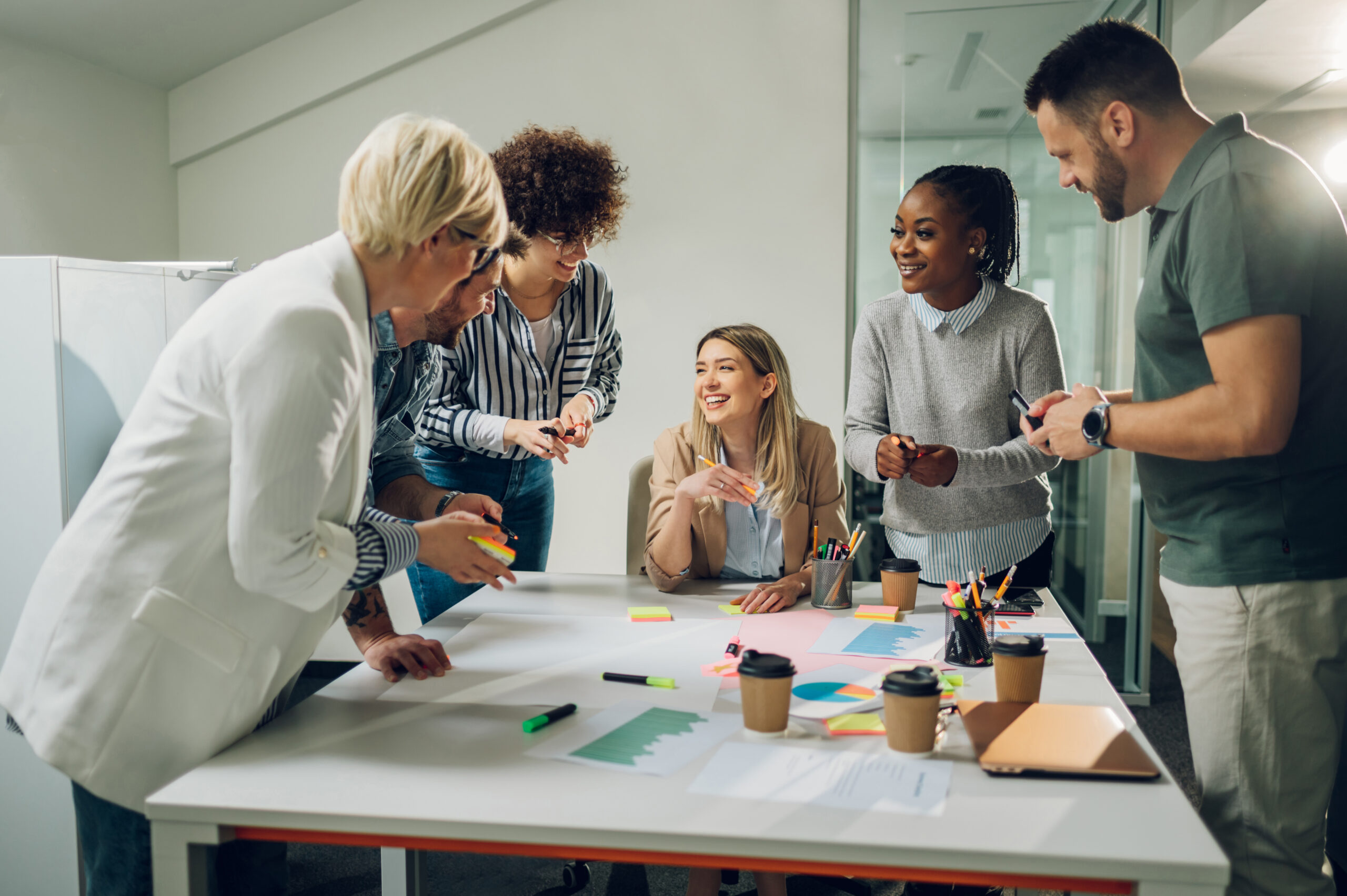 business team on a meeting in a modern bright office, business team working together at corporate briefing gathered at table in the office, coherence, aligning goals