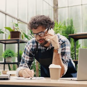 businessman talking on cellphone while standing with vendors and suppliers, Own business concept