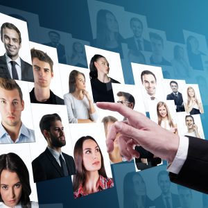 How to know in if you're about to make a Bad Hire, Businessman hand going through candidate picture gallery on blue background, Social media and recruiting concept