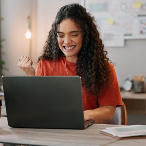 Woman, happy and laptop in office with celebration, success, land your dream client