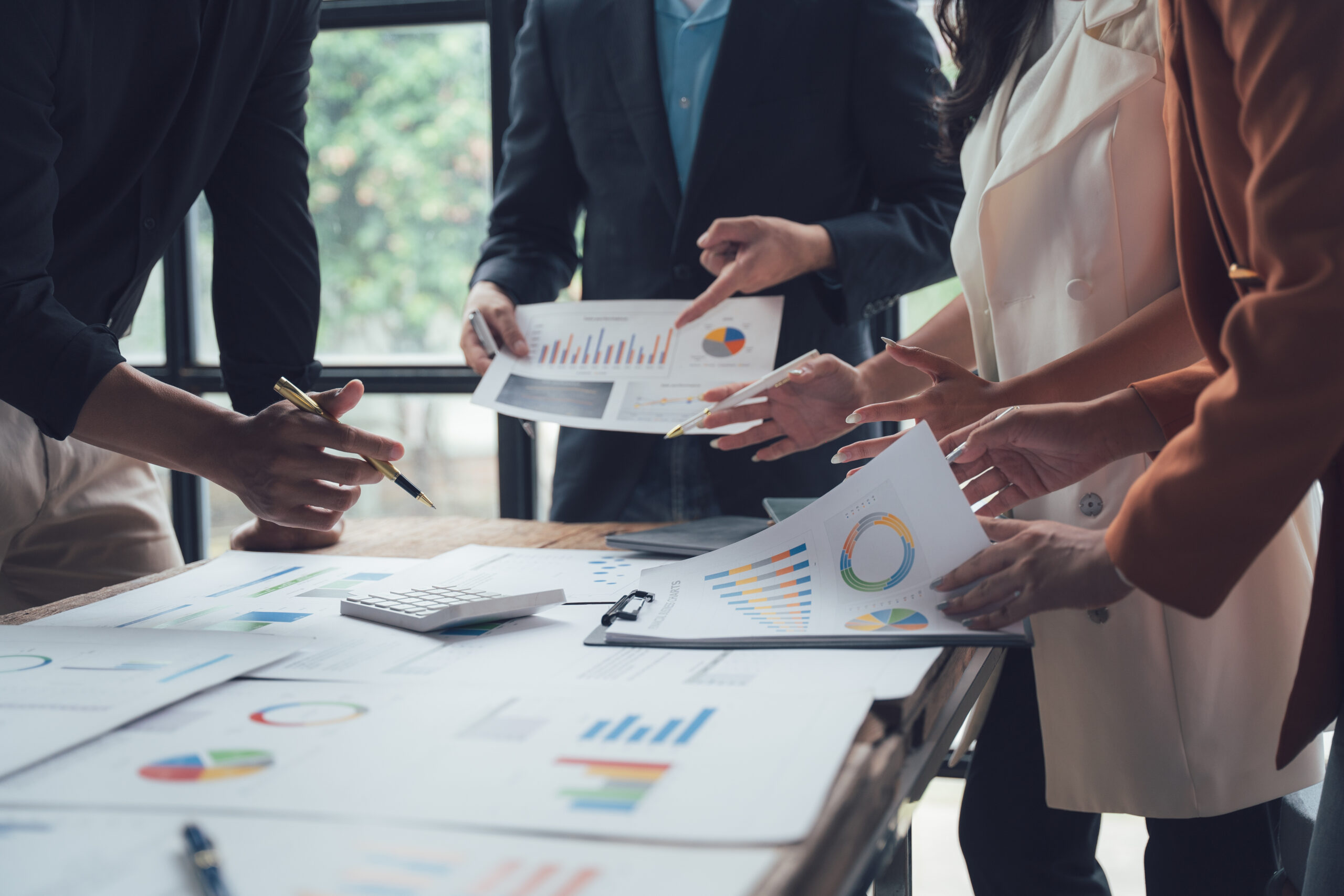 charts in a modern office setting, reflecting the focused energy and shared ambition of a high-performing team, CEOs, Creating Business Plans