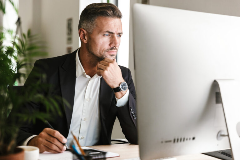 confident businessman wearing suit working in office and looking on computer, business that can operate without you