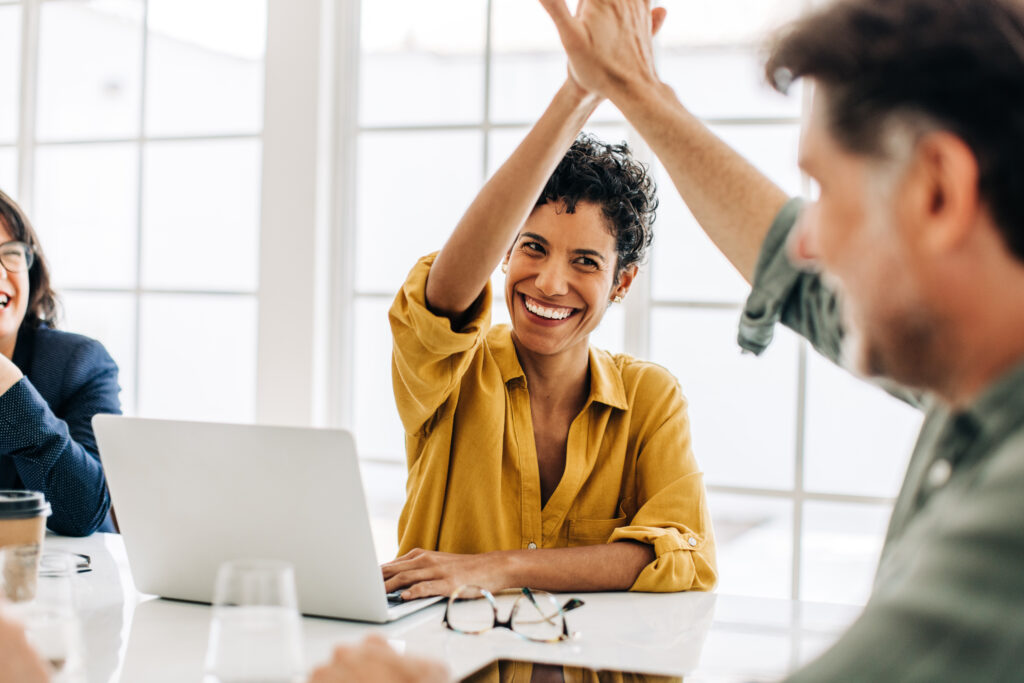 Business people celebrating success in an office, Teamwork and goal achievement, successful people