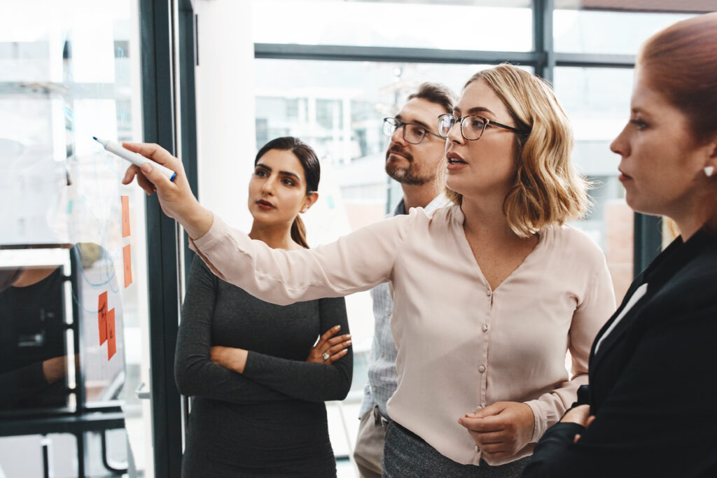 group and collaboration with notes on board with review, listening and planning with brainstorming, questions and discussion with strategy in office, keeping your company culture on track