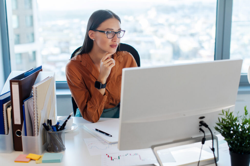 lady manager sitting in front of computer monitor, working in modern office interior, close your accountability loop