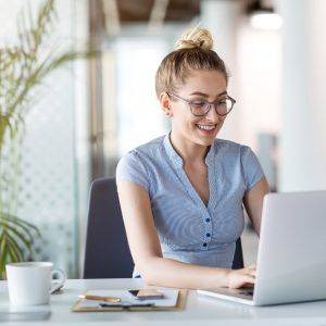 business woman working on laptop in office, business, lead with integrity, accountability loop