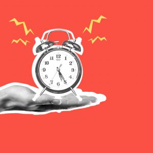 Human hand holding alarm clock on red background, solid block of focus time