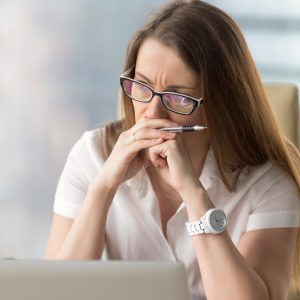 Worried businesswoman sitting alone in office, female entrepreneur frowning thinking about problem solution, if your business volume is drying up